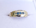 1897 Victorian sapphire and diamond navette ring showing three blue sapphires and two old-cut diamonds in domed gold setting