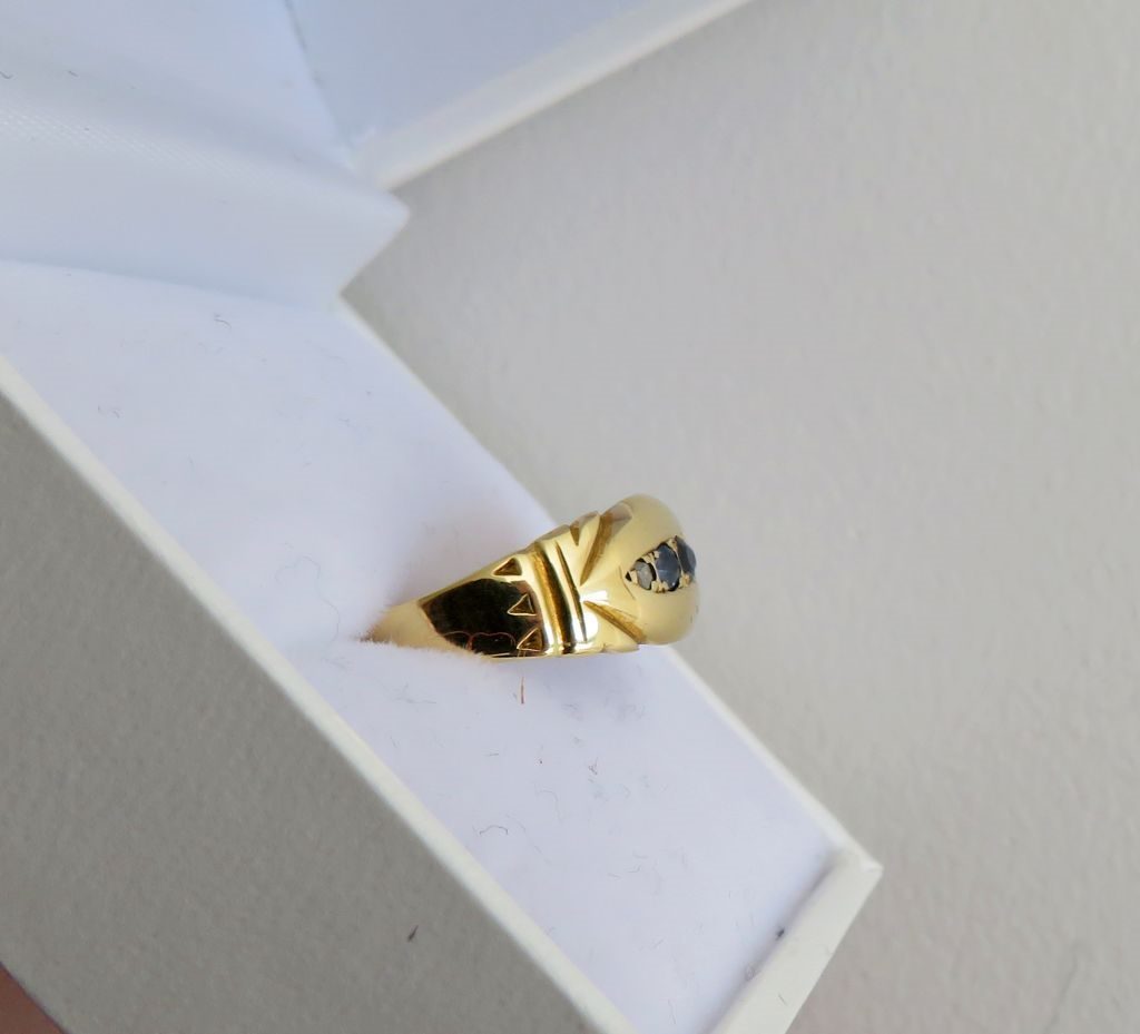1897 Victorian sapphire and diamond navette ring side view in white jewellery box showing engraved shoulders